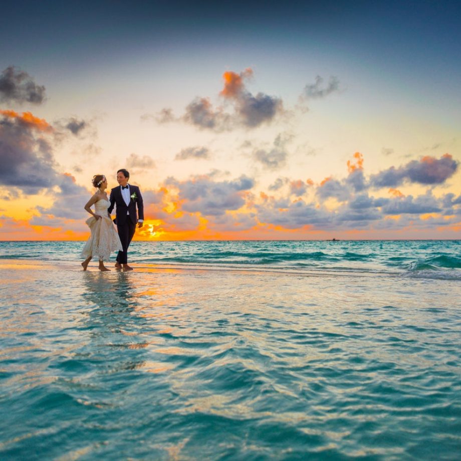 man-and-woman-walking-of-body-of-water-1024993